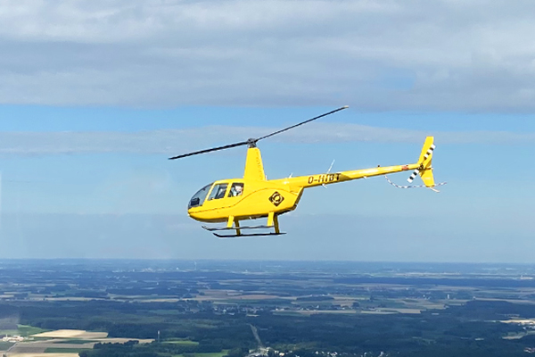 yellow r44 helicopter over linz hoersching